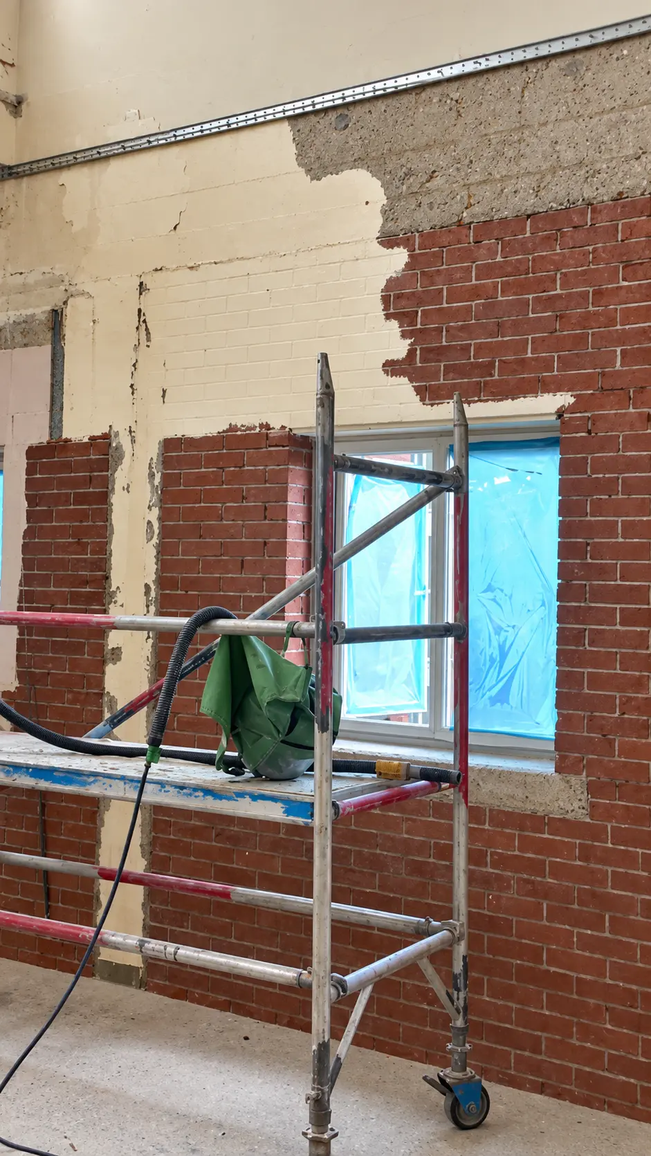Interior brick cleaning and coating removal in progress