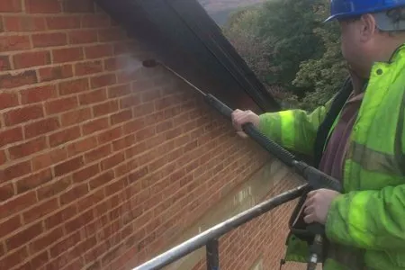 Cleanwalls operative blast cleaning brickwork at height
